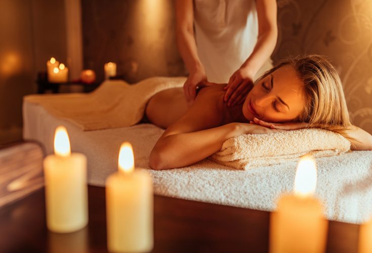 Woman enjoying a massage with candles